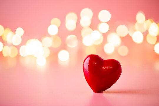 The Red Heart Shapes On Abstract Light Pink Glitter Background. Love Concept For Valentines Day.