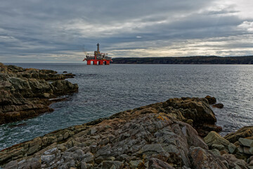 Deep water drill rig is moored near shore after finishing an exploration well, Newfoundland and...
