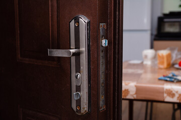 Lock on an iron door with a handle close-up.