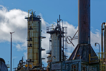 Sections of an old industrial oil refinery showing its age and rusting.