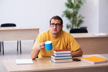 Young male student having break during exam preparation
