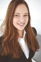 Business woman standing in white office. Student girl and success concept