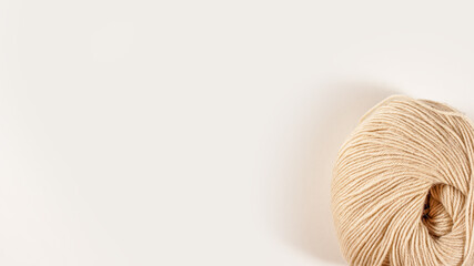 Round skein of wool on a white background.
