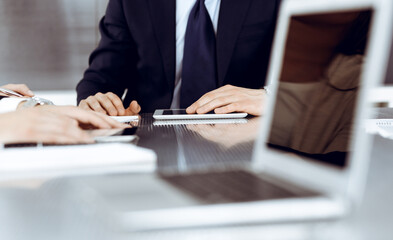 Business people working together at meeting in a modern office. Unknown businessman and woman with colleagues or lawyers at negotiation about contract