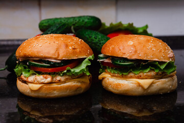 Homemade cheeseburger made from turkey. The ingredients used were poultry breast, cucumber, tomato, lettuce, cheese and sauce.