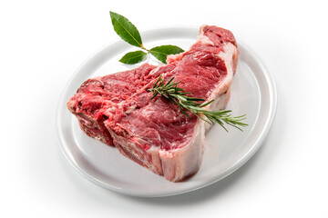 Raw T-bone steak with bay leaf and rosemary