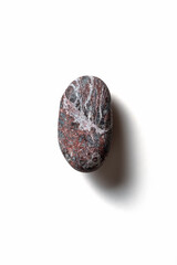 Fototapeta premium Single pebble on a white background