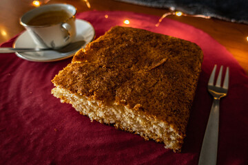Sponge Cake, with a cup of caffe and a light background