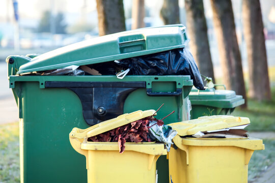 Overflowing Trash Can On The Street. Garbage Sorting