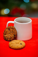 christmas drinks and cakes on background tree