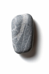 Single pebble on a white background