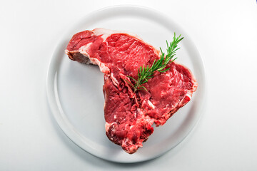 Raw T-bone steak with rosemary