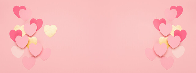 Pink, golden paper hearts on pastel pink background. Festive holiday greeting card for Valentines, Birthday, Woman or Mothers Day.