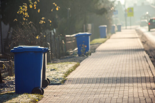 Garbage cans in line on the side of the road. Environmental protection concept