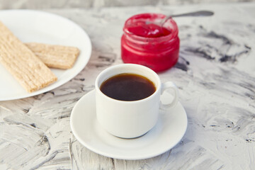 Crispbread with jam for Breakfast on a gray background. A jar of Fresh Honey with foam is next to a Cup of coffee. A minimum of calories. proper nutrition