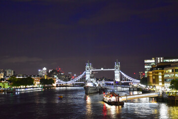Naklejka na ściany i meble View of the River Thames at night with the illuminated London Bridge and HMS Belfast.