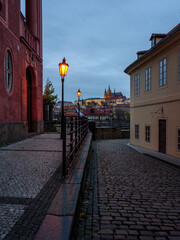 Historic street in Prague's city center with the view on Prague Castle in the evening