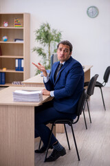 Young male employee working in the office