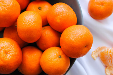 Ripe clementine tangerines close-up on the table.