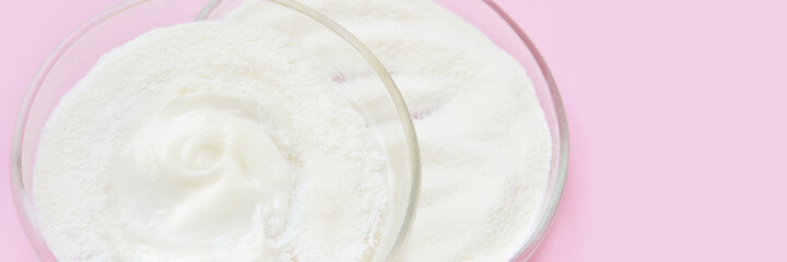 Collagen white powder. Pastel color background. Health product. Woman cosmetics concept. Sport supplement. Skincare cosmetics. Horizontal banner. Pink monochrome