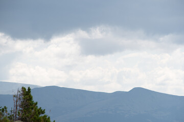 Fototapeta premium View of calming mountain valley with ridge on horizon. Gentle hills in blue haze.
