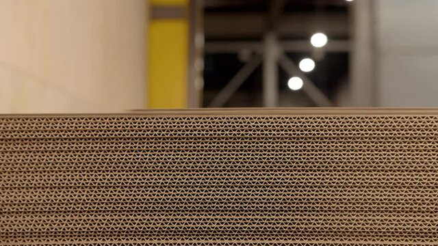 Putting sheets of corrugated cardboard paper on stack