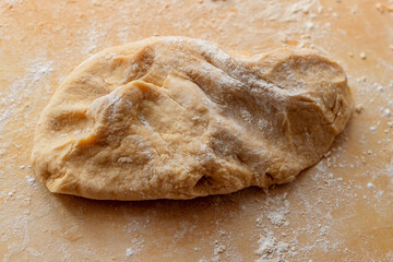 Hands kneading the dough.