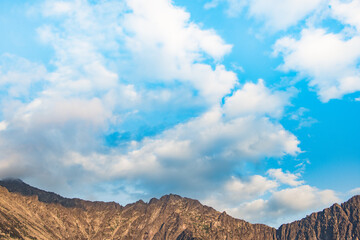 Blue sky and clouds over the rocks, beautiful cloud landscape over mountain range