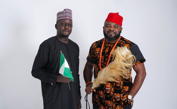 Portrait Of Two Nigerian Men From Different Tribes Dressed In Traditional Attire