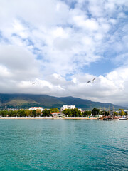 Fototapeta premium Sea, mountains and sky in white clouds