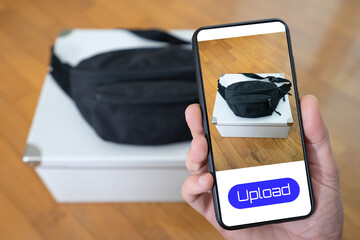 View of a person taking a photo of a waist pack to upload in a second hand clothes app