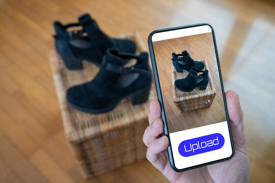 View of a person taking a photo of a pair of shoes to upload in a second hand clothes app