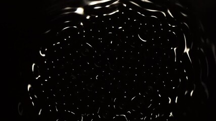 Pulsing wave patterns fluctuate in black space.