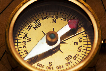 Old vintage retro compass on ancient map background. Travel geography navigation concept background.