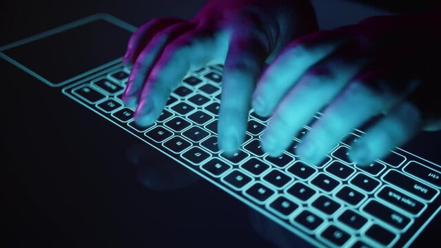 Hands are typing on a blue futuristic digital keyboard in 4k