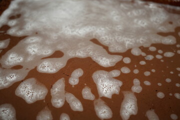 Foam from detergent on the turn of the tray