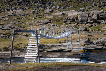 Fototapeta na wymiar Hiking bridge over a river in the wilderness, Norway