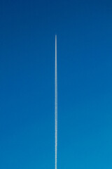 plane in blue sky, straight line