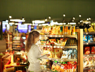 supermarket shopping, face mask,Woman choosing a dairy products at supermarket.
