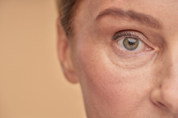 Mature woman with wrinkled eyes in studio