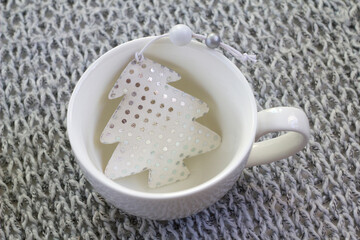 Chrisrmas tree decoration and white cup