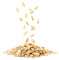 Raw oatmeal falls on a heap on a white background. Isolated