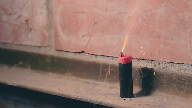 Firecracker Was Lighted Up With a Gas Lighter then Explode Against a Brick Wall. Many Small Particles Flew in a Different Directions - Static Shot