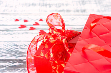 Festive greeting card for valentines day with red gift box and red paper bg. Copy space for text.