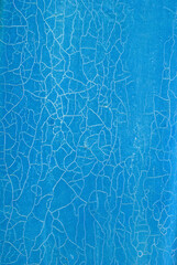 white cracks of old paint on a blue background