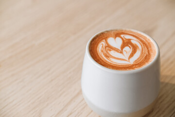 Fancy cup of coffee or hot chocolate in modern hipster cafe. Modern breakfast and coffee house concept. Close up