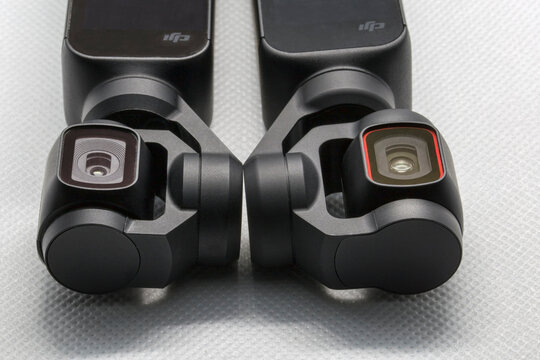 Close up view tree of three-axis gimbal stabilize compact cameras produced by DIJ. On left picture Osmo Pocket lens and on right Pocket 2 lens