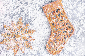 Christmas composition. Golden toys, on snowflakes background. New year decorations