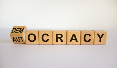 Democracy or autocracy symbol. Turned a cube and changed the word 'autocracy' to 'democracy'....