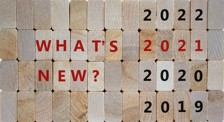 New year 2021 symbol. Wooden blocks with the words '2021 whats new'. 2019, 2020, 2022 numbers. Beautiful wooden background, copy space. Business and trends 2021 new year concept.